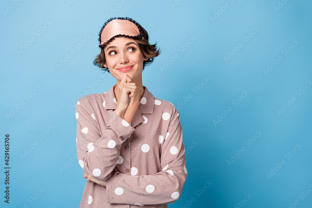 Photo of young girl happy positive smile think hand touch chin guess dream look empty space isolated over blue color background