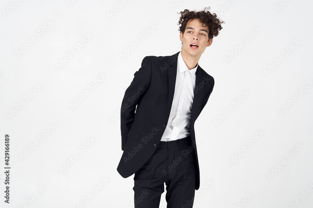 guy in a classic suit on a light background curly hair portrait guy in a classic suit on a light background curly hair portrait