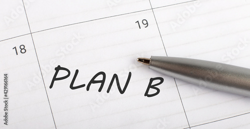 Text PLAN B written on calendar planner to remind you an important appointment with a pen on isolated white background.