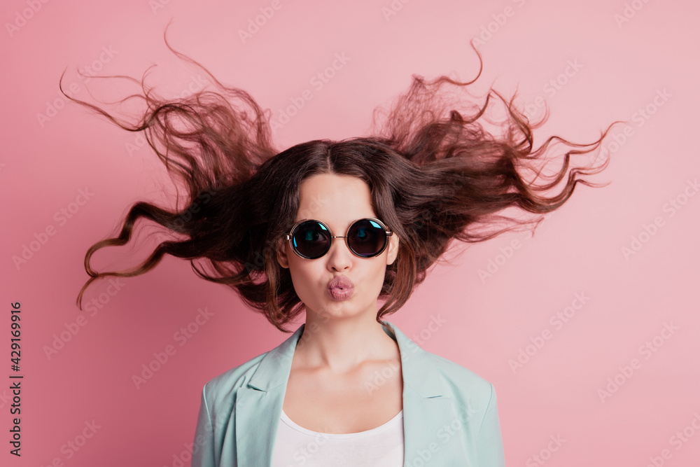 Joyful excited surprised young woman with flying hair blow romantic air kiss Joyful excited surprised young woman with flying hair blow romantic air kiss