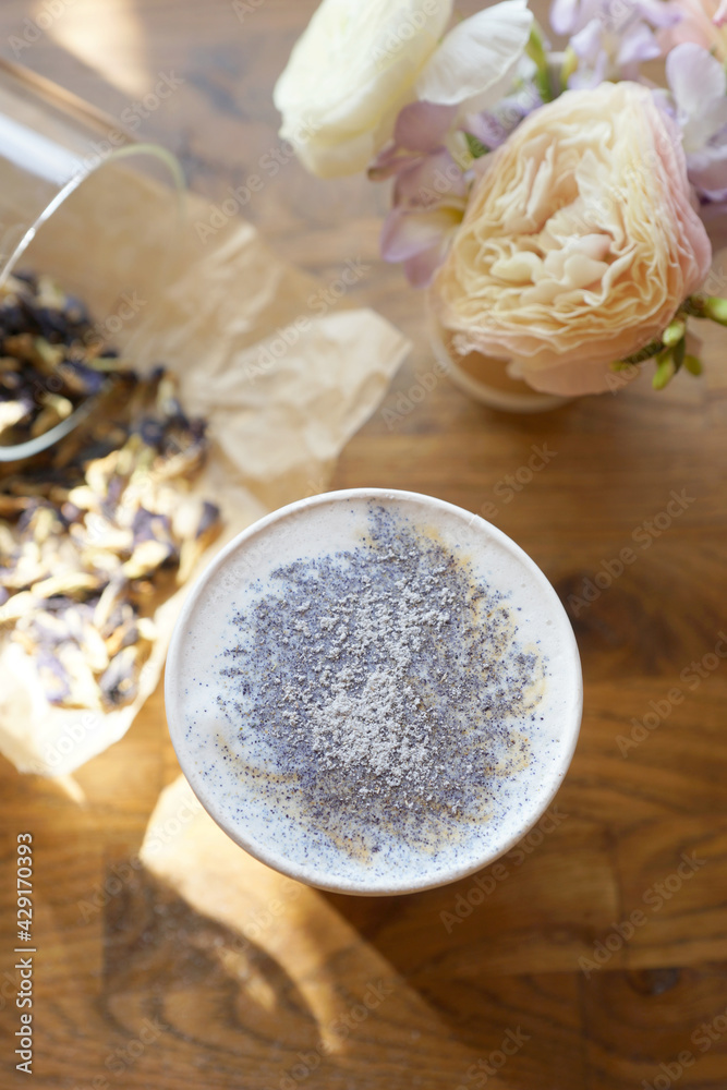 Cappuccino in a paper cup and with powdered sugar on top Cappuccino in a paper cup and with powdered sugar on top
