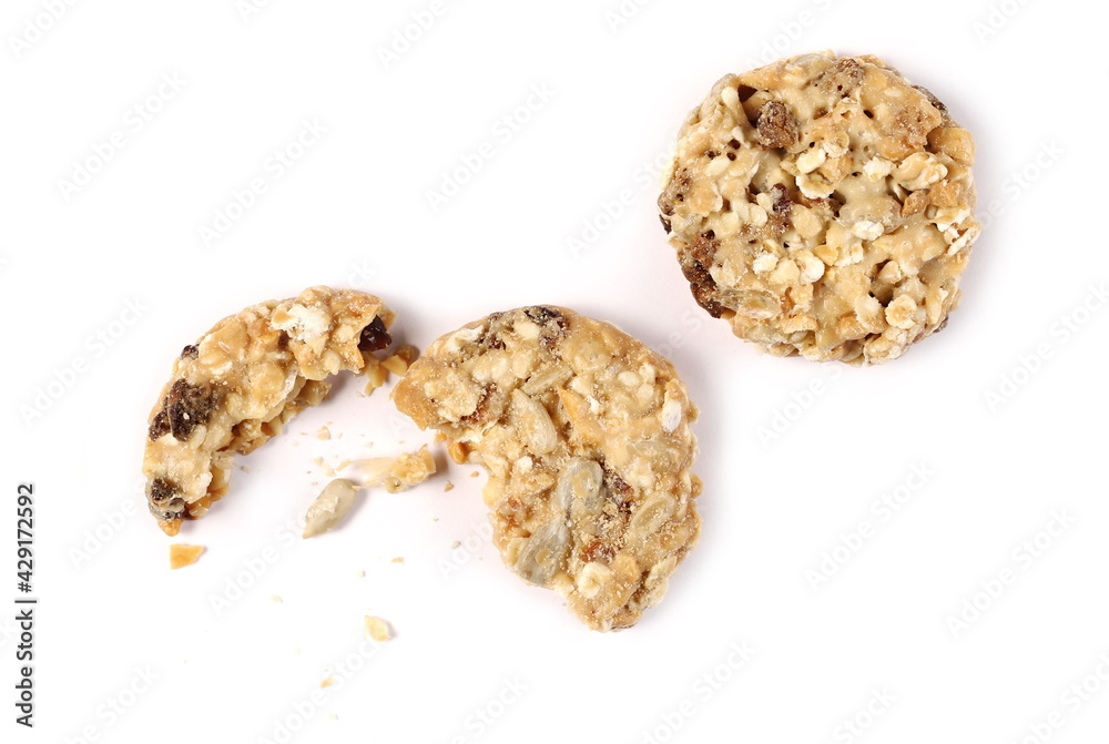 Muesli cookies, granola biscuits with peanuts, raisins and sunflower seeds isolated on white background, top view Muesli cookies, granola biscuits with peanuts, raisins and sunflower seeds isolated on white background, top view