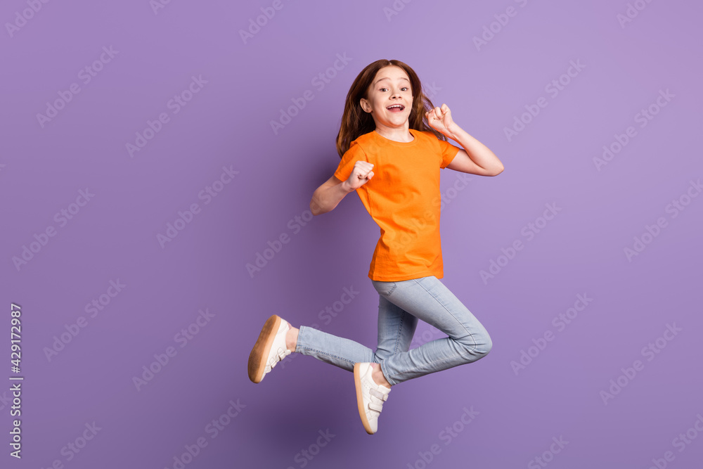 Full length body size view of pretty cheerful girl jumping rejoicing having fun isolated over violet purple color background