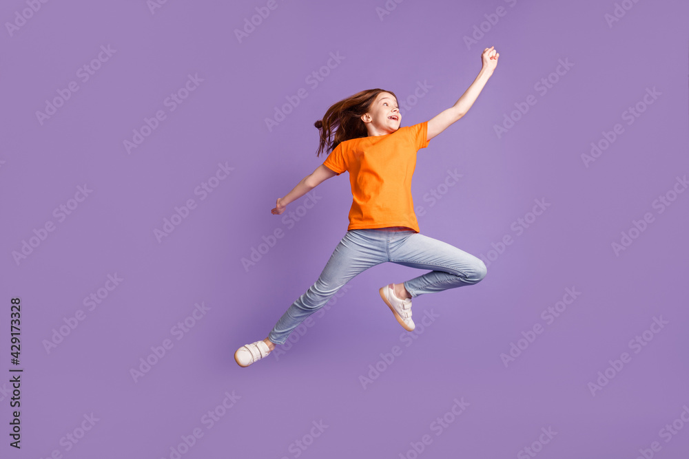 Full length body size view of pretty cheerful pre-teen girl jumping striving isolated over violet purple color background