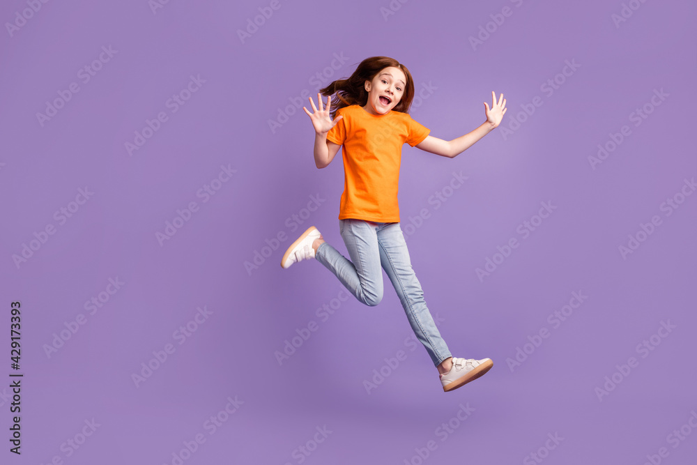 Full length body size view of lovely cheerful pre-teen girl jumping walking good mood isolated over violet purple color background