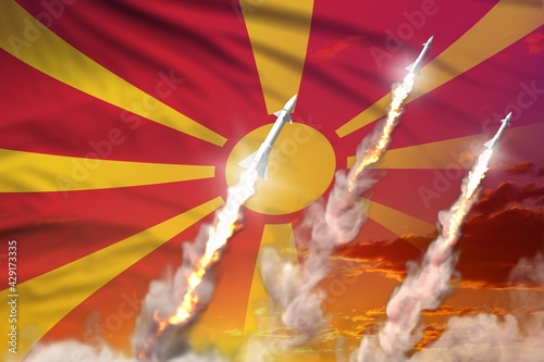 Macedonia ballistic missile launch - modern strategic nuclear rocket weapons concept on sunset background, military industrial 3D illustration with flag photo