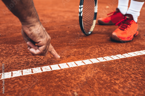 Canvas Print close up of referee showing that the ball was out on tennis court