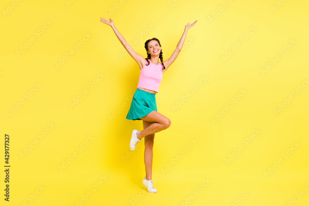Full body photo of happy attractive young woman raise hands wear summer outfit isolated on vivid yellow color background Full body photo of happy attractive young woman raise hands wear summer outfit isolated on vivid yellow color background