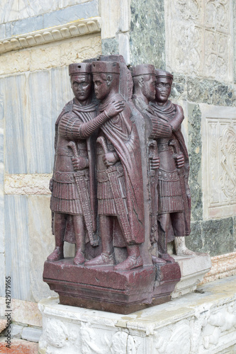 Portrait of the Four Tetrarchs at a corner of the façade of St Mark's Basilica in Venice, Italy. It is an ancient porphyry sculpture group of four Roman emperors from around 300 AD. 