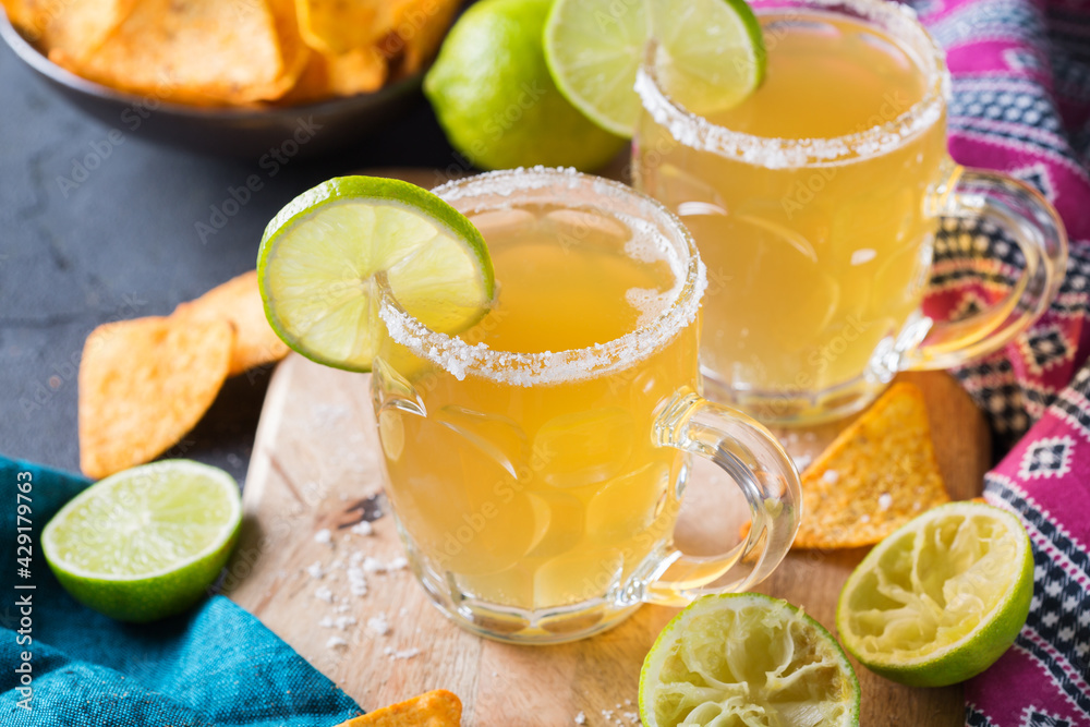 Mexican alcohol cocktail chelada with light beer and lime juice Mexican alcohol cocktail chelada with light beer and lime juice
