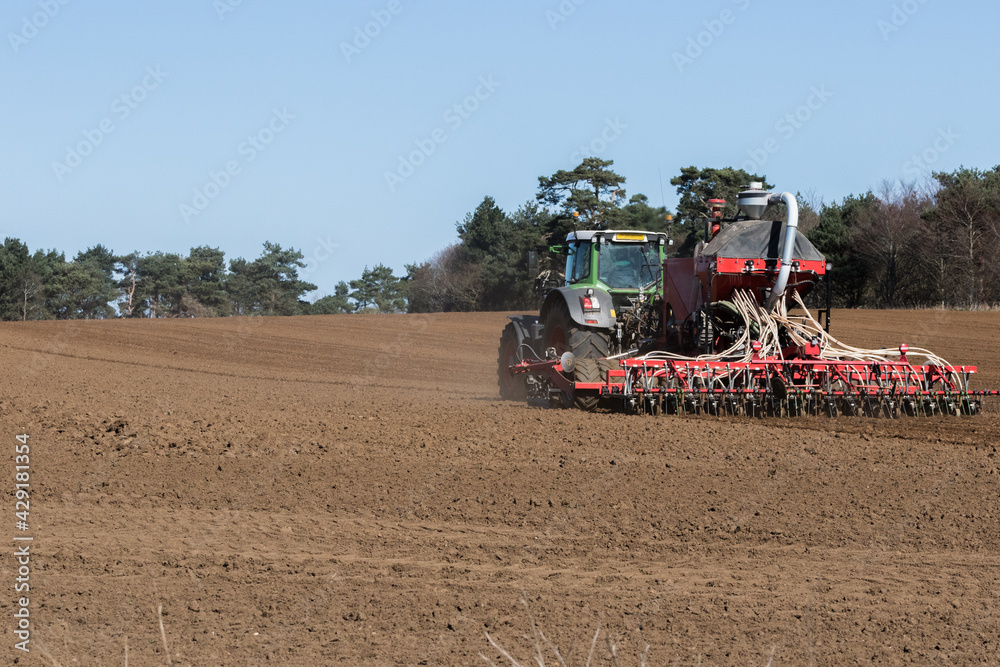 Fototapeta premium In the midst of the global corona pandemic, farmers worldwide are still working hard growing next years crop and ensuring the food supply lines can continue