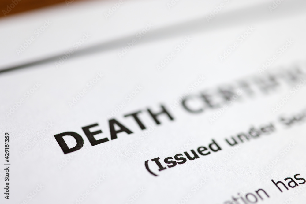 Death certificate is on table. Paperwork after death of relative