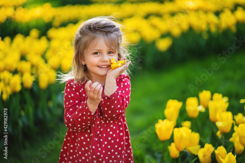 happy childhood concept. smiling girl with a flower in her hands