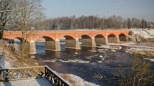 Long brick bridge over Venta river in Kuldiga, Latvia.