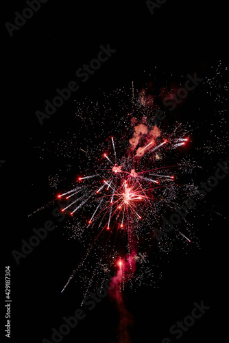 colored night explosions in black sky. beautiful multi colored fireworks in night sky. New years eve fireworks celebration. shining fireworks with bokeh lights in night sky. glowing fireworks show.