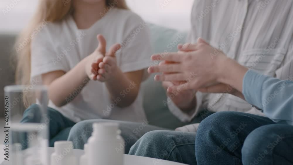Unrecognizable Mother Spraying Sanitizer On Daughters' Hands Indoors, Cropped Unrecognizable Mother Spraying Sanitizer On Daughters' Hands Indoors, Cropped