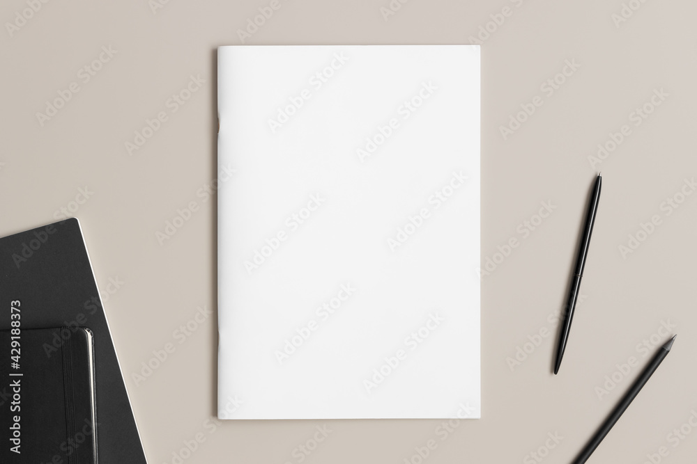 Magazine mockup with workspace accessories on the beige desk. Magazine mockup with workspace accessories on the beige desk.