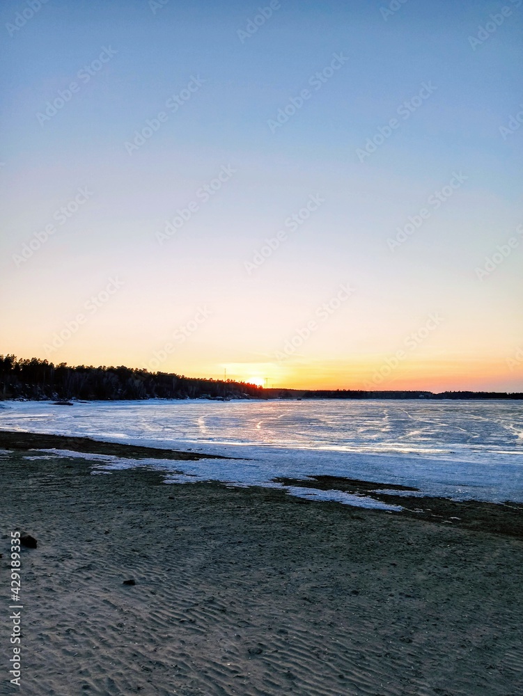 frozen seashore at sunset