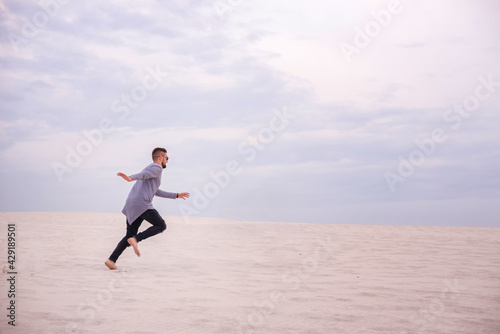 Man running on the sand at sunset