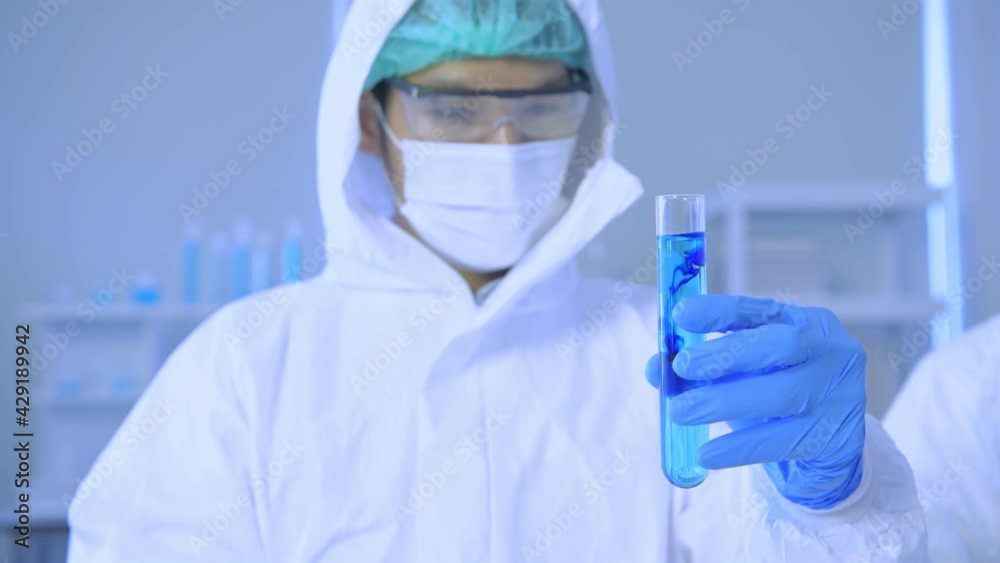 Research concept of 4k resolution. Scientists are examining the solution in a test tube. Research concept of 4k resolution. Scientists are examining the solution in a test tube.
