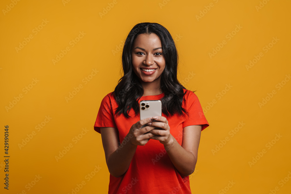 Young black happy woman smiling and using mobile phone Young black happy woman smiling and using mobile phone