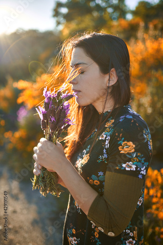 Young girl picking up lavender flowers