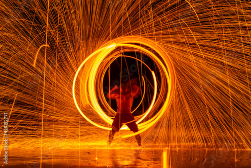 A man show the swirly fire show at Koh Samet, Thailand