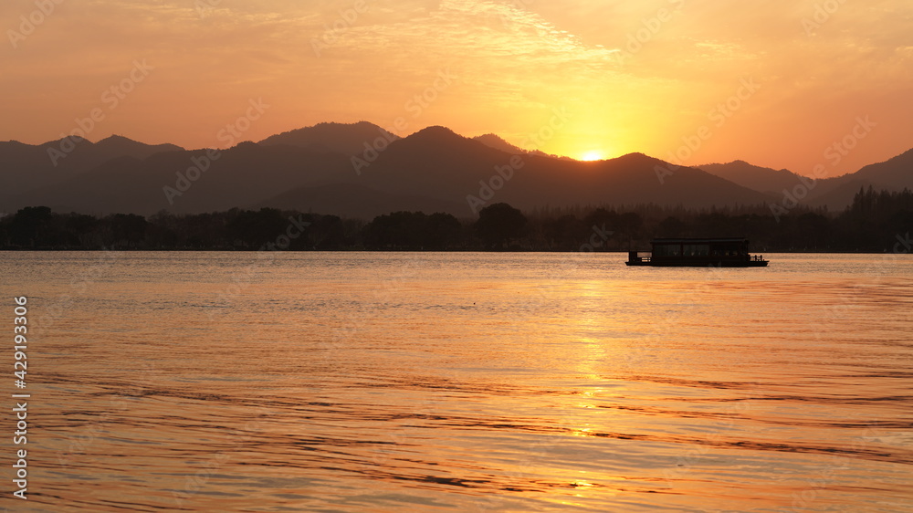 The beautiful sunset view standing near the lake in winter