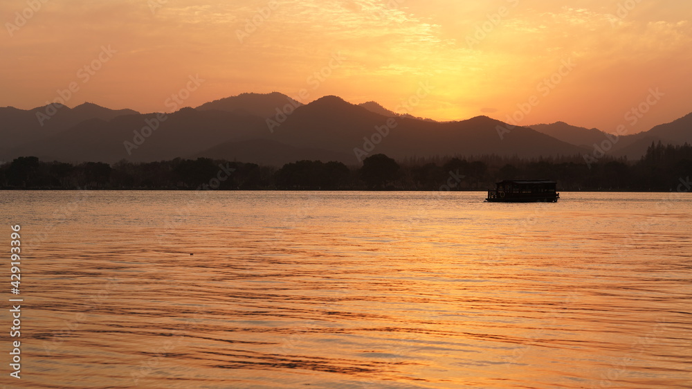 The beautiful sunset view standing near the lake in winter