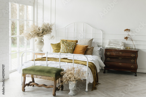 Stylish modern bedroom interior with vintage white bed