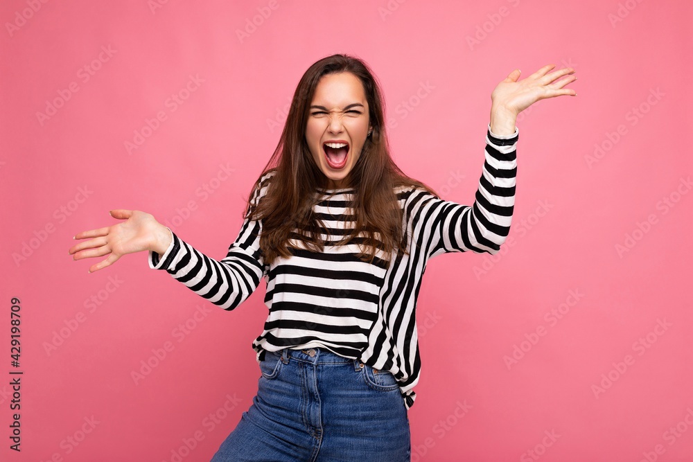 Photo shot of cute attractive pretty positive happy young brunette woman wearing casual striped longsleeve isolated over colorful background with copy space and having fun Photo shot of cute attractive pretty positive happy young brunette woman wearing casual striped longsleeve isolated over colorful background with copy space and having fun
