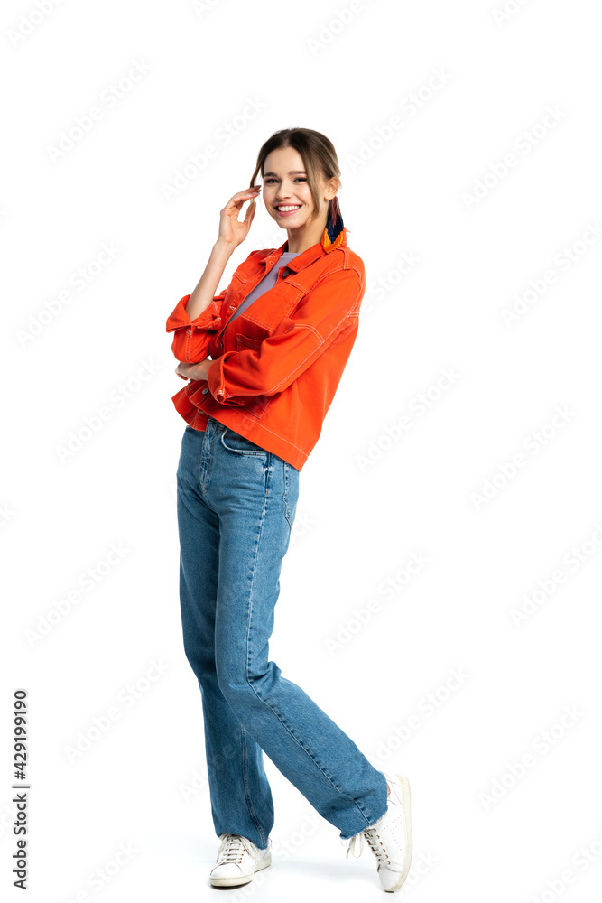 full length of cheerful young woman in orange shirt standing isolated on white full length of cheerful young woman in orange shirt standing isolated on white