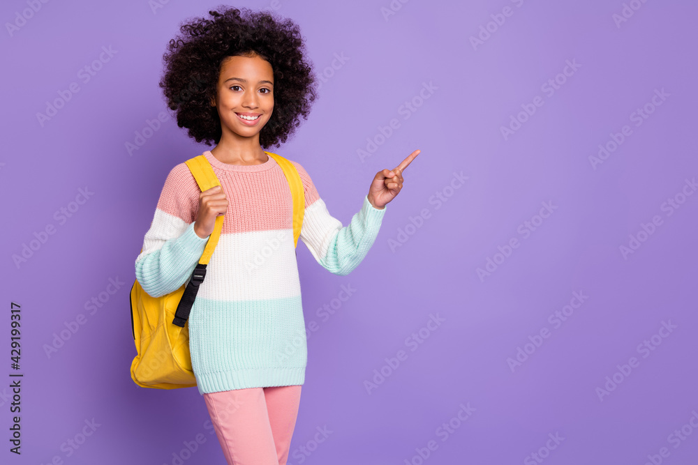 Photo of optimistic girl wear bag sweater trousers point empty space isolated on violet background