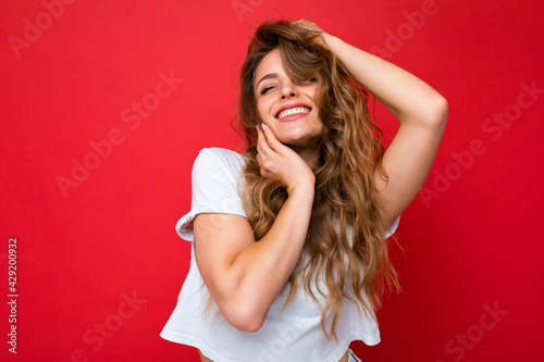 Close-up portrait of nice-looking attractive lovely lovable pretty cute winsome gorgeous cheerful cheery wavy-haired blonde woman isolated on pastel color background wearing stylish clothes