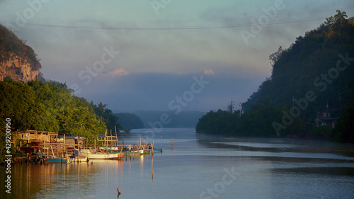 Yumuri river in Matanzas, Cuba with calm water, gentle sky and tall hills photo