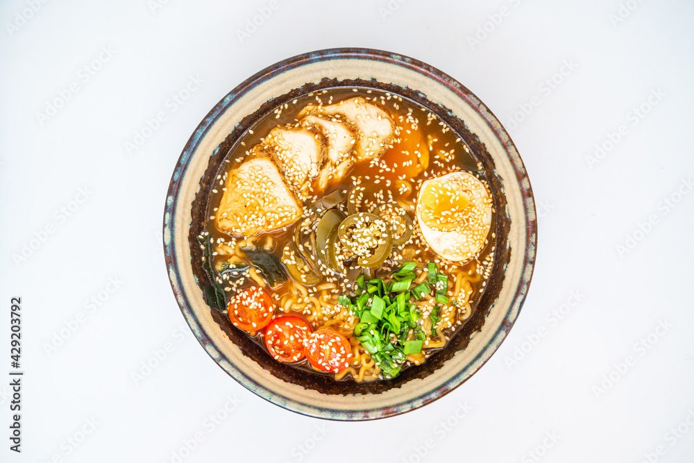 Ramen noodles soup with egg in bowl isolated on white.