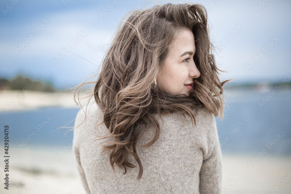 portrait of a beautiful sensual young woman, hair develops the wind, brunette with emotions, hands hair and face, seaside wind outside portrait of a beautiful sensual young woman, hair develops the wind, brunette with emotions, hands hair and face, seaside wind outside