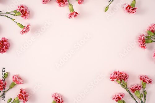 Design concept of Mother's day holiday greeting with carnation bouquet on pink table background