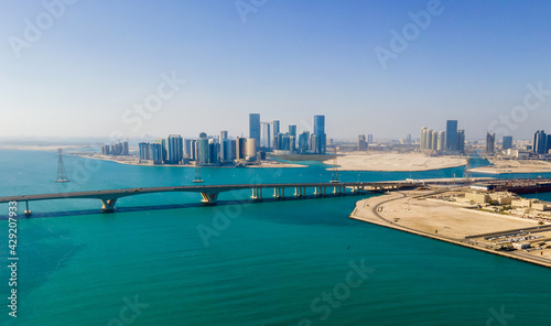 Aerial view of Abu Dhabi skyline rising over the seaside forming modern waterfront of the UAE capital © creativefamily