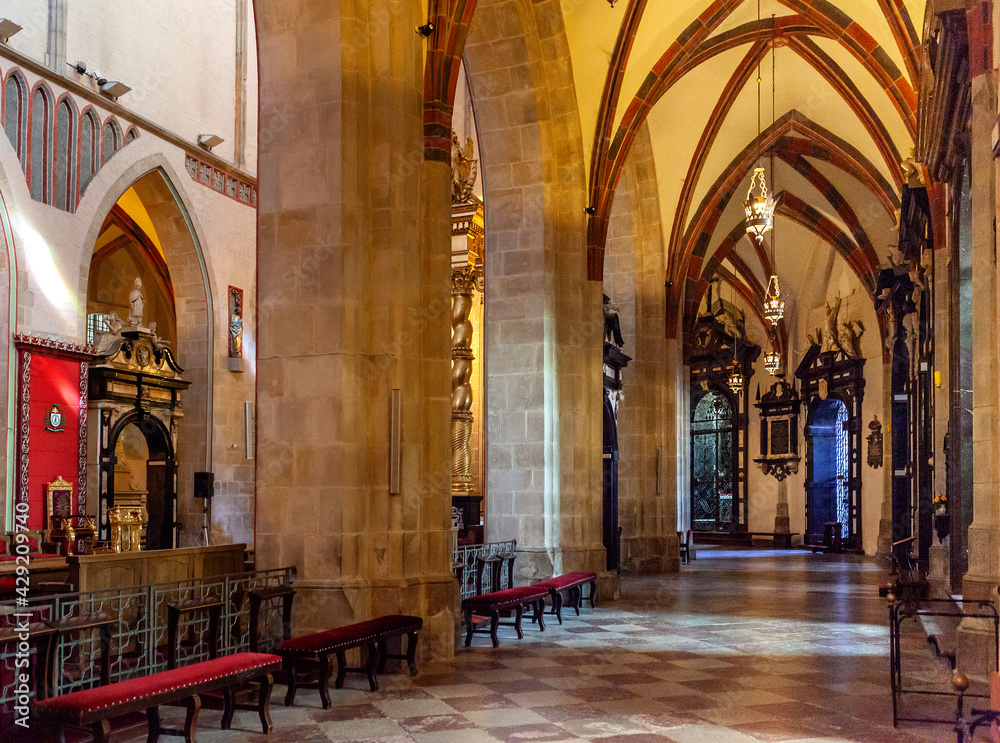 Gothic aisle of Gniezno Cathedral with symbolic sarcophagus and coffin of St. Adalbert, Sw. Wojciech, martyr in old town Lech Hill historic city center of Gniezno, Poland - obrazy, fototapety, plakaty 