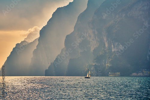 Vászonkép View of the beautiful Lake Garda surrounded by mountains, Scenic view of sunset