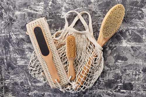 A set of natural body care items in an eco-friendly reusable bag on a concrete table. Personal care, eco-friendly devices and packaging concept