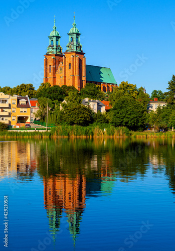 Cathedral of Virgin Mary Assumption and St. Wojciech at Lech Hill across Jelonek Lake in old town historic city center of Gniezno in Grater Poland