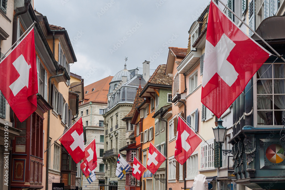 Flags on residential buildings in the old town in Zurich, Switzerland