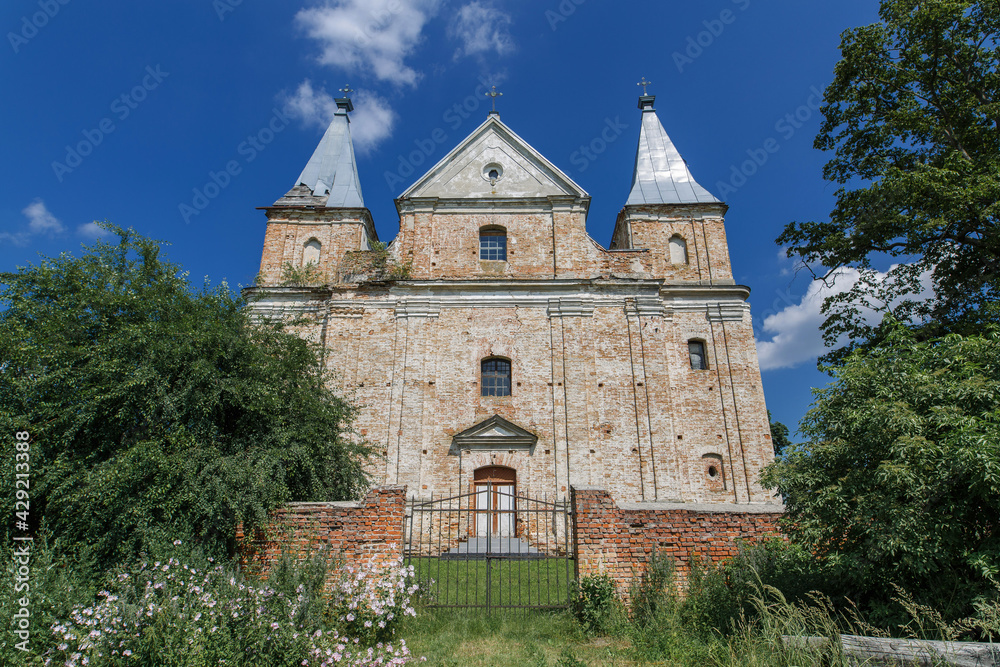 ancient brick Roman Catholic church in Ukraine. exterior of an old brick church.travel to ukraine.  historical monuments of architecture