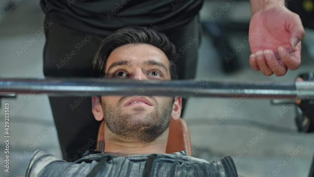 Caucasian athlete exercising by weight training with fitness trainer. Caucasian athlete exercising by weight training with fitness trainer.