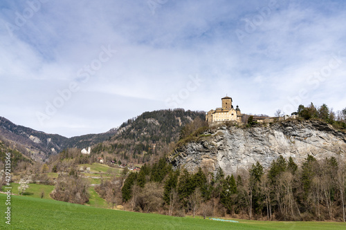 mountain landscape in the Swiss Alps with a view of the Ortenstein Castle on a hilltop