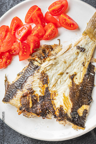 fried flounder grilled baked fish seafood tomato vegetables second course snack trend meal copy space food background rustic. top view diet pescetarian photo