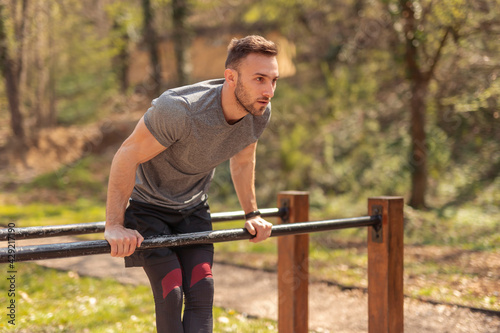 Man having a training session in a street workout park