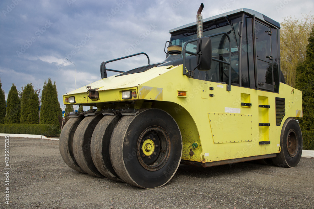 large light yellow roller for paving work. Improvement of the city. Equipment for road construction and repair, rent, purchase, leasing